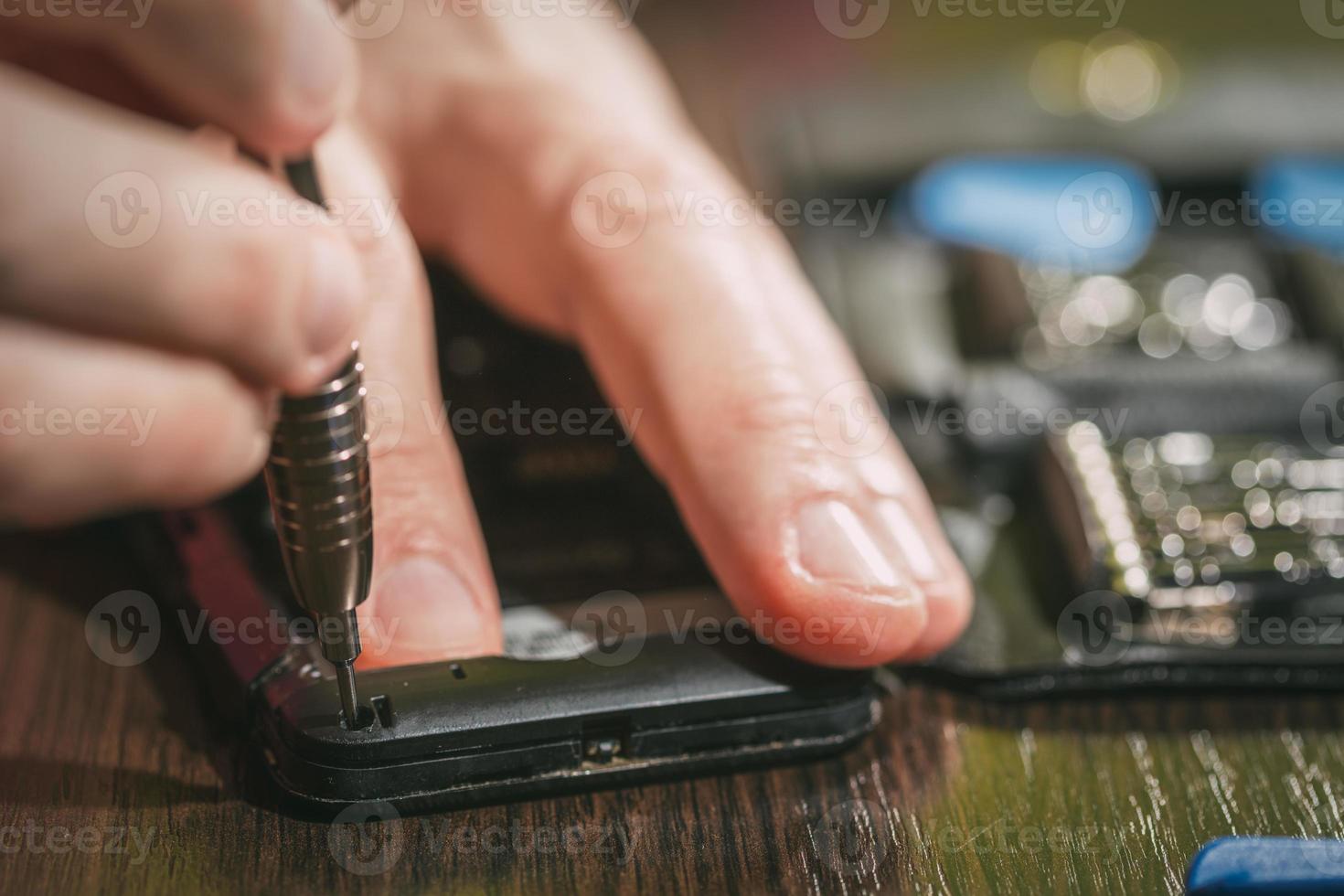 Man Repairing A Mobile phone photo
