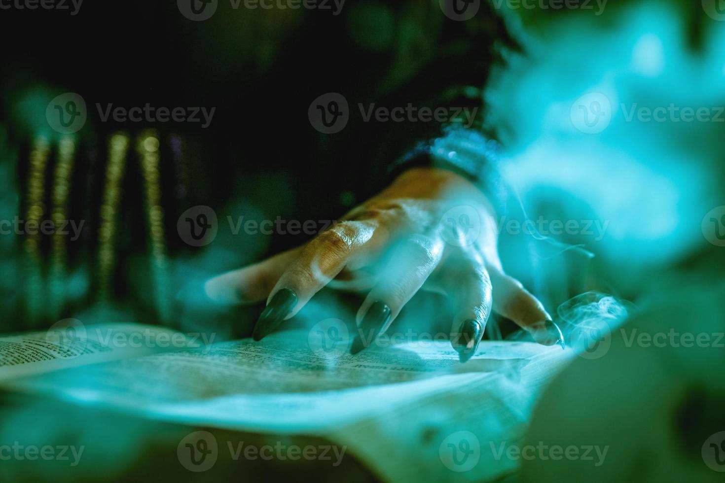 Witch's Hand On Magic Book photo