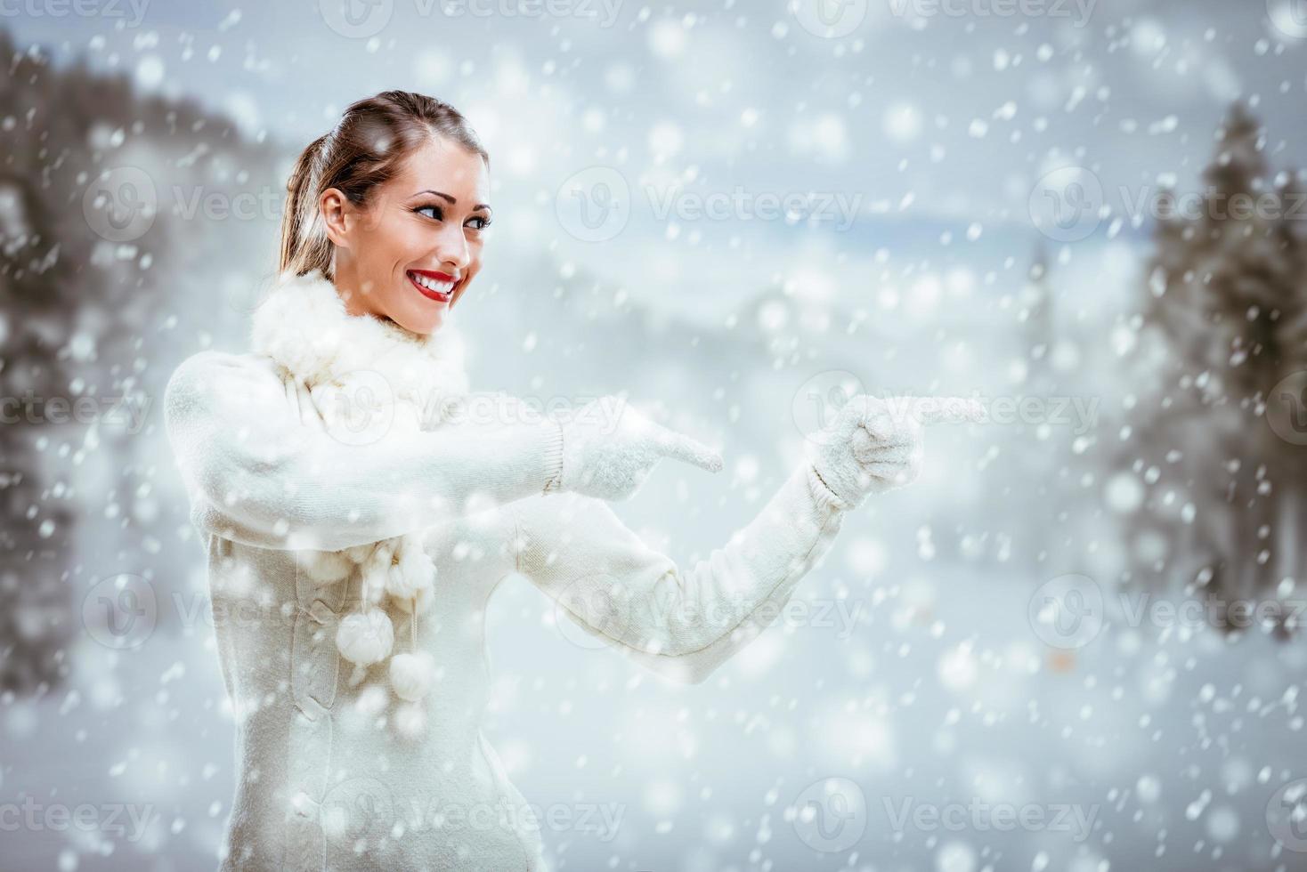 Girl In Winter Clothes Pointing Away photo