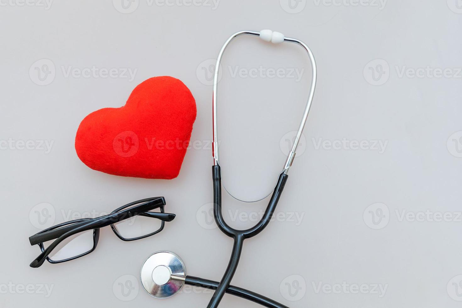 Medicine equipment stethoscope or phonendoscope glasses and red heart isolated on white background. Instrument device for doctor. Health care life insurance concept photo