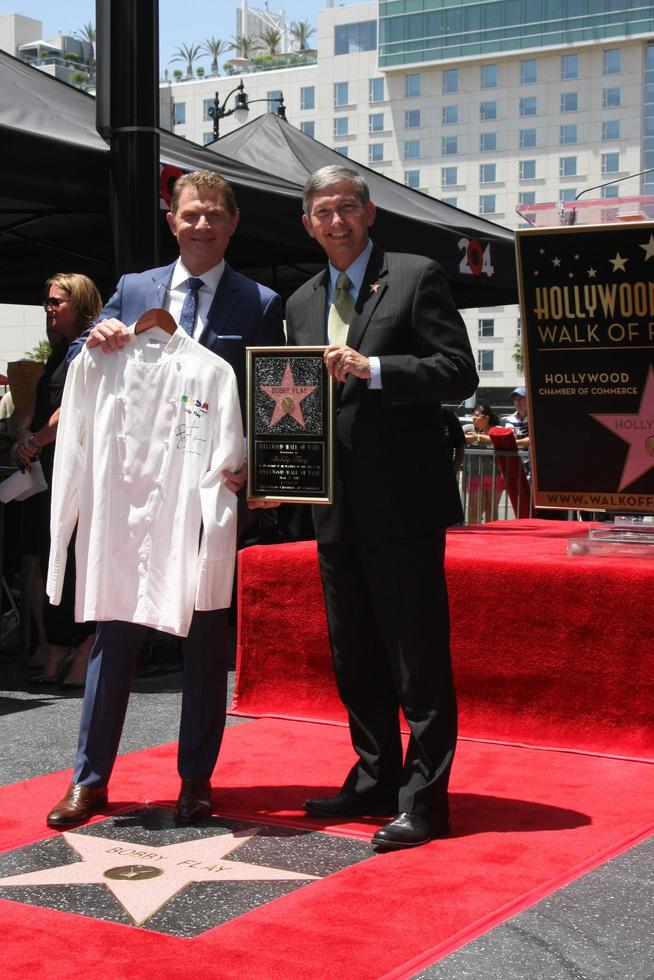LOS ANGELES, JUN 2 - Bobby Flay presenting Leron Gubler with MESA Grill chef jacket for future WOF museum at the Bobby Flay Hollywood Walk of Fame Ceremony at the Hollywood Blvd on June 2, 2015 in Los Angeles, CA photo