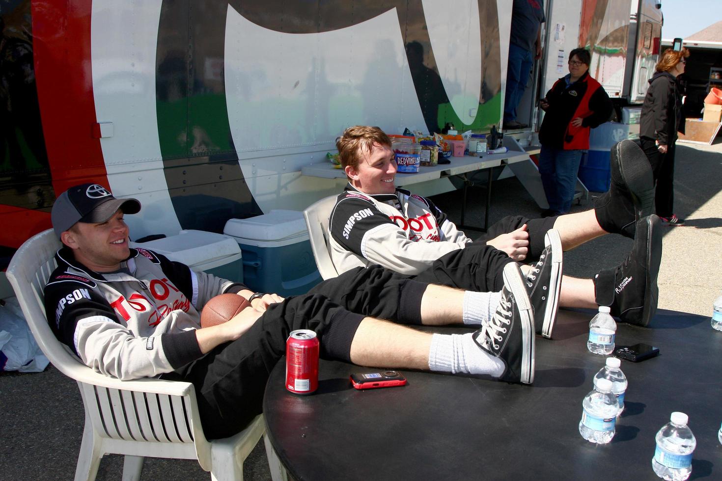 LOS ANGELES, MAR 23 - Brett Davern, Dakota Meyer Medal of Honor Winner aetting some sun during a break at the 37th Annual Toyota Pro Celebrity Race training at the Willow Springs International Speedway on March 23, 2013 in Rosamond, CA   EXCLUSIVE PHOTO