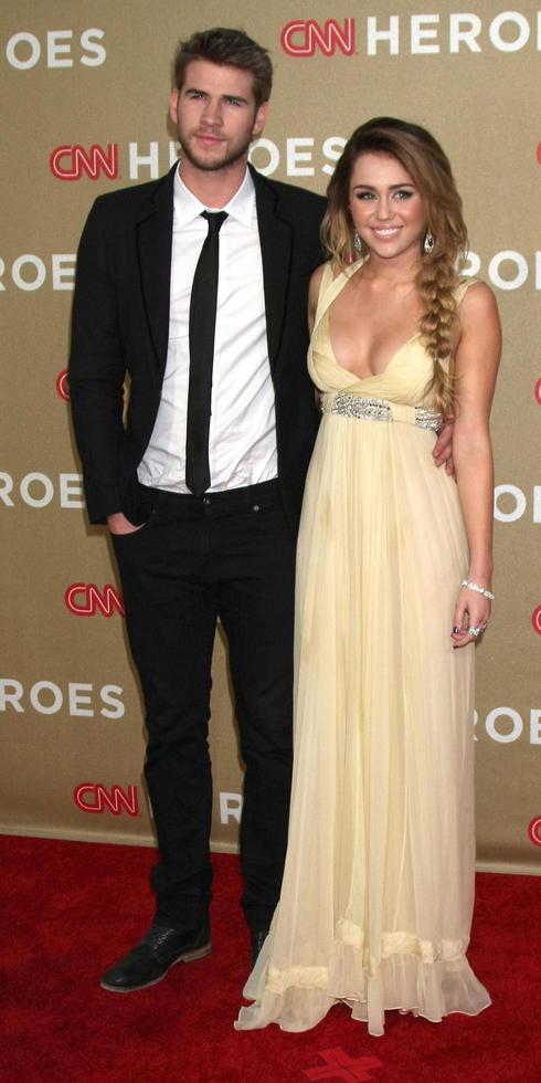LOS ANGELES, DEC 11 - Liam Hemsworth, Miley Cyrus arrives at the 2011 CNN Heroes Awards at Shrine Auditorium on December 11, 2011 in Los Angeles, CA photo