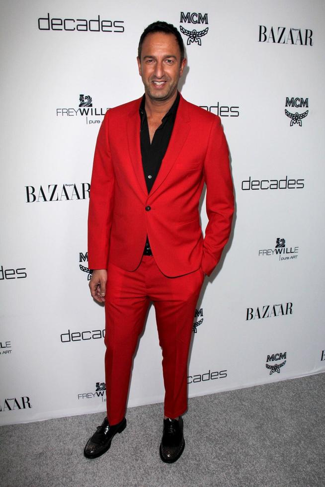 LOS ANGELES, FEB 28 - Christos Garkinos arrives at the Harper s Bazaar