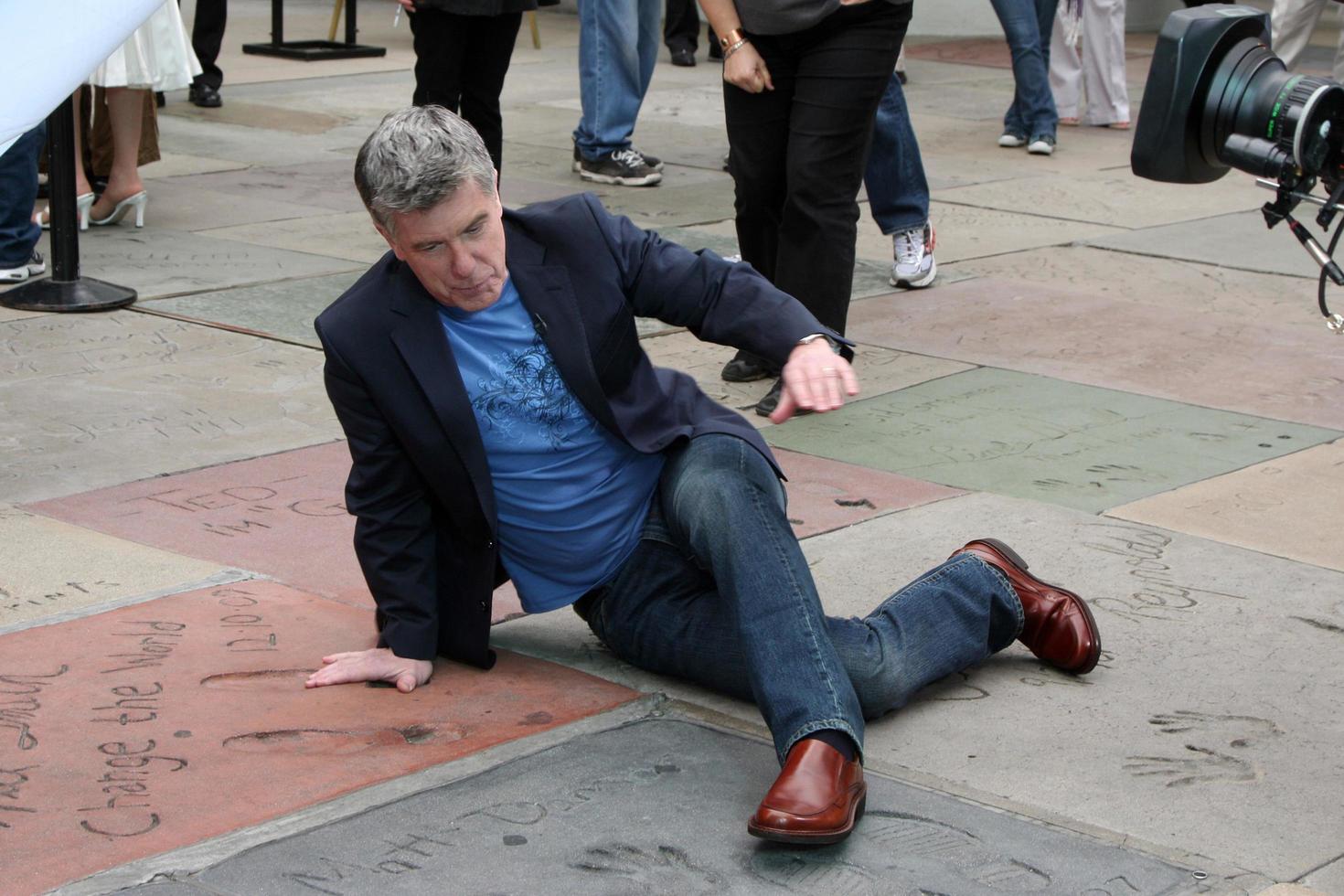 Tom Bergeron playing Celebrity Twister on the handprints and footprints  on a America s Funniest Home Video TV Shoot in front of Grauman s Chinese Theater  in Los Angeles , CA on  March 11, 2009 2009 Kathy Hutchins   Hutchins Photo
