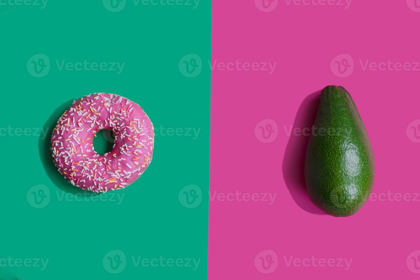 donut and avocado on a bright background. Proper nutrition. Harmful and correct food. Healthy lifestyle. Choice in nutrition photo