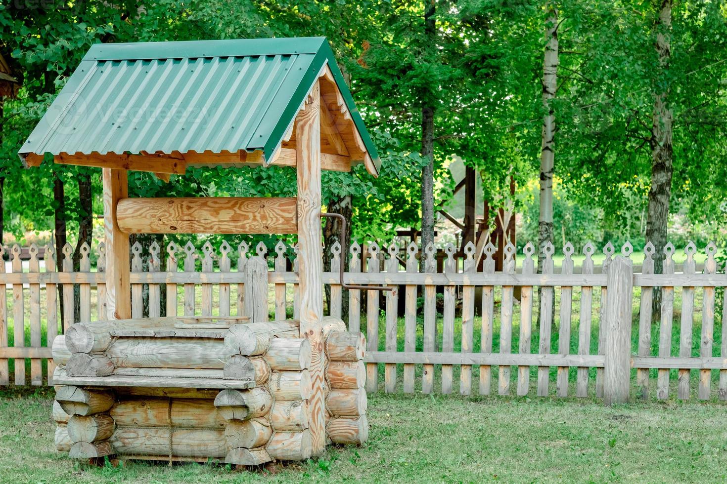 wooden well, copy space. Russian traditions. Village life photo