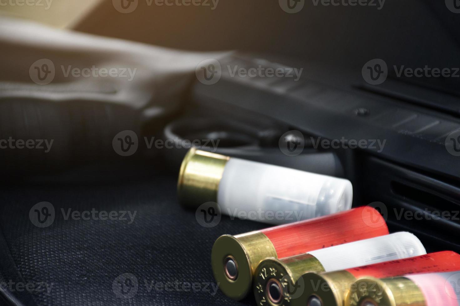 12 gauge red hunting cartridges for shotgun on wooden background. photo