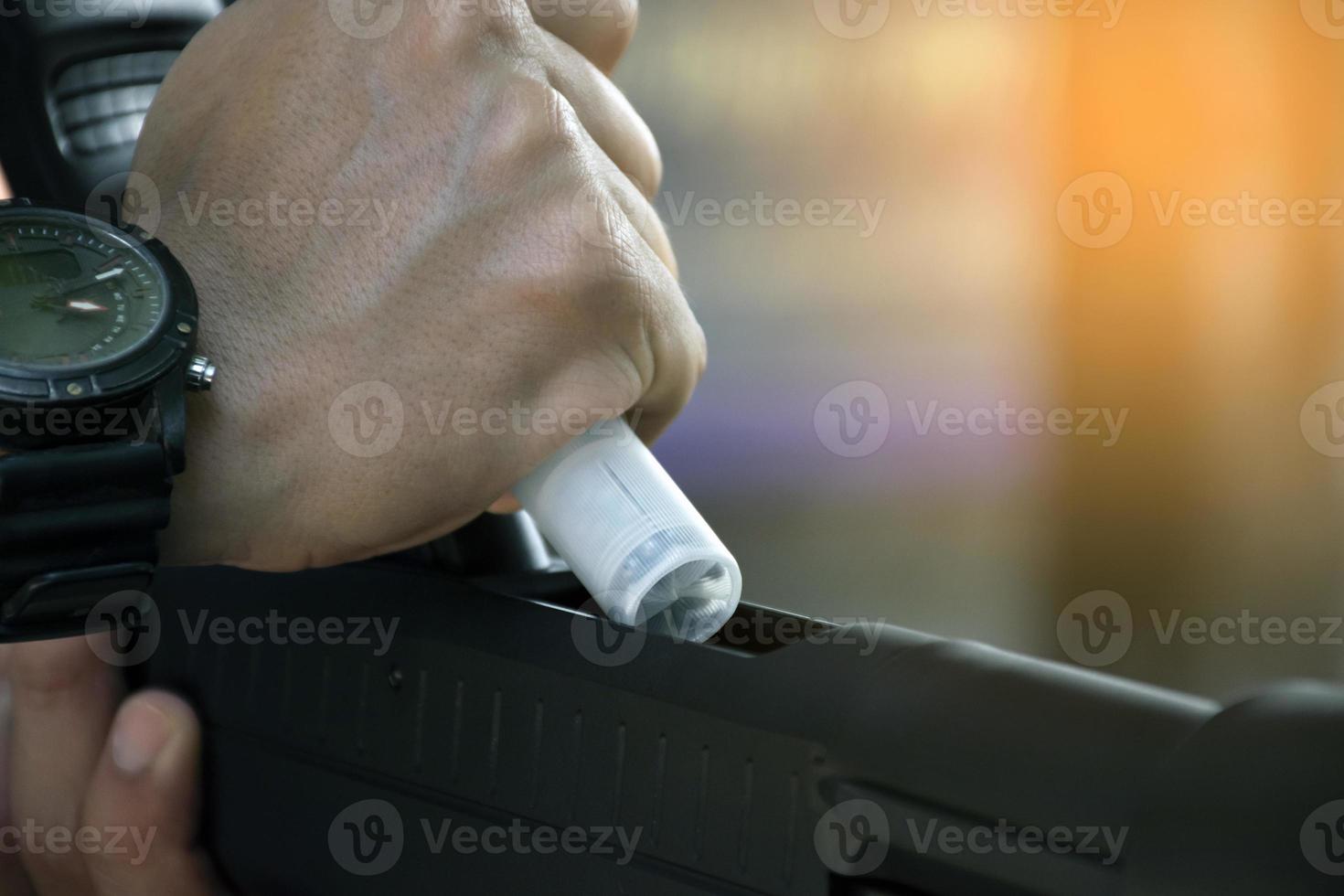 shotgun shooter is changing and inserting new bullet into shotgun, soft and selective focus. photo