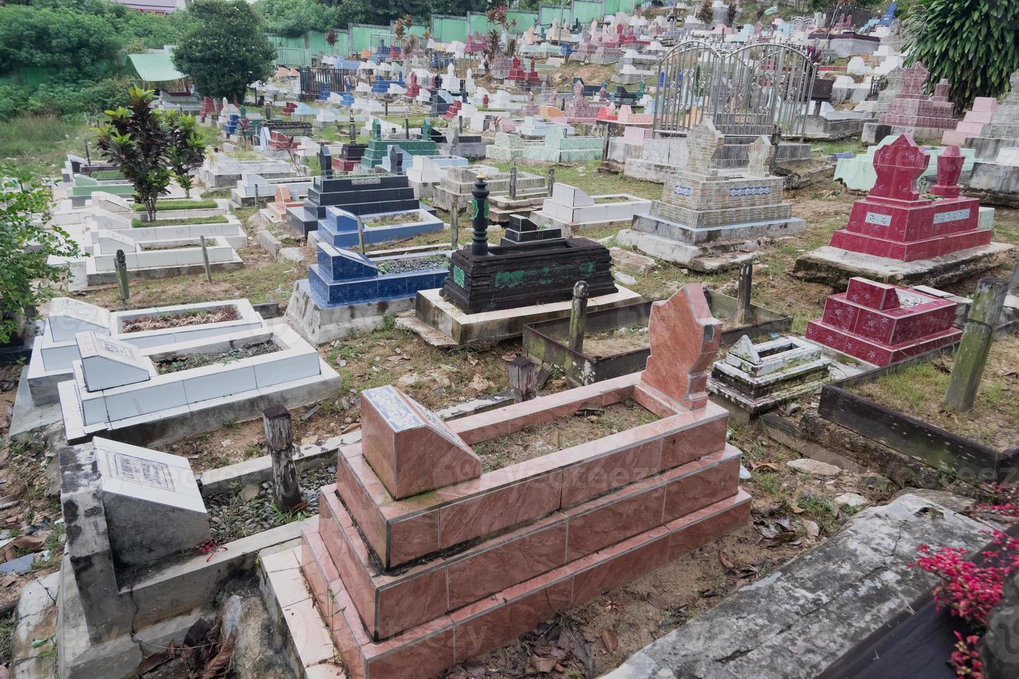 selective focus on black Muslim tombs made of ironwood. Muslim funerals in Indonesia photo