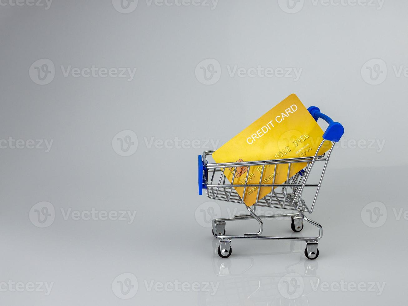 Shopping car and mockup credit card  on light and shadow background. shopping online concept. photo