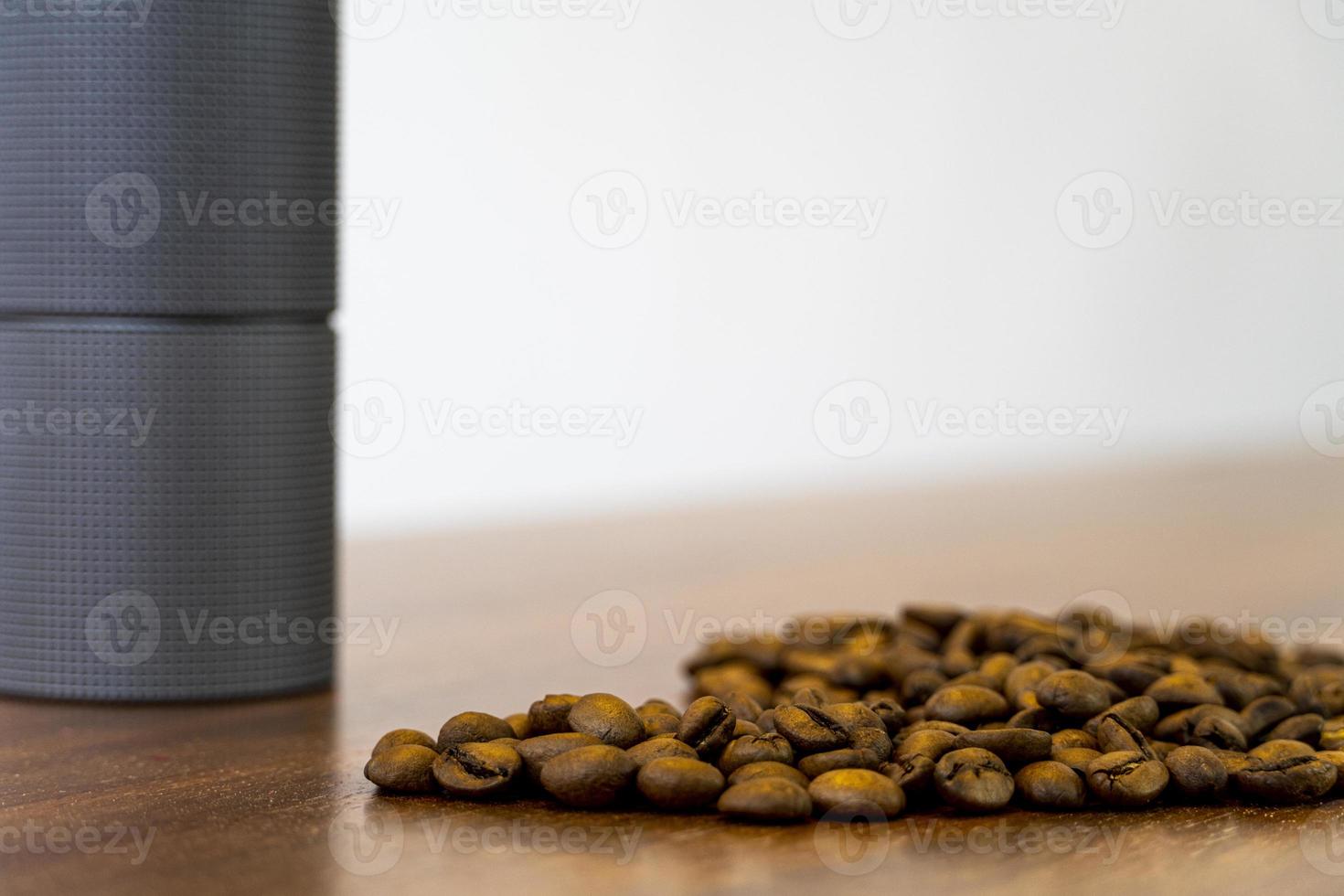 Coffee beans on a pile of ground coffee are close-ups. photo