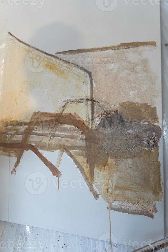 Artists workshop. Canvas, paint, brushes, palette knife lying on the table. photo