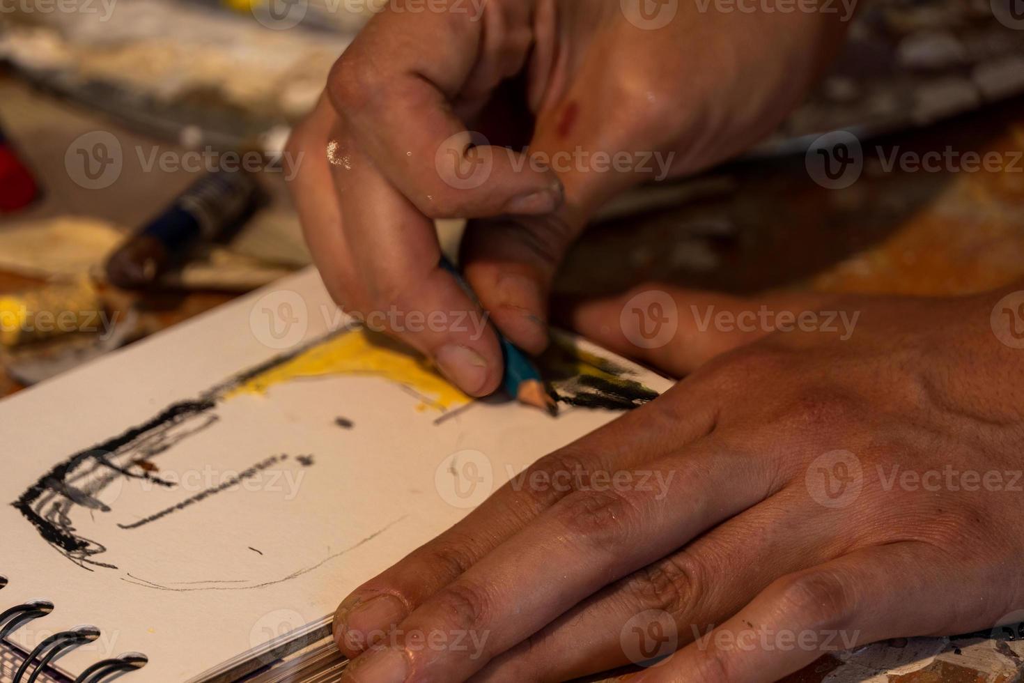 young latin woman, in her own painting studio, creates paintings different artistic techniques photo