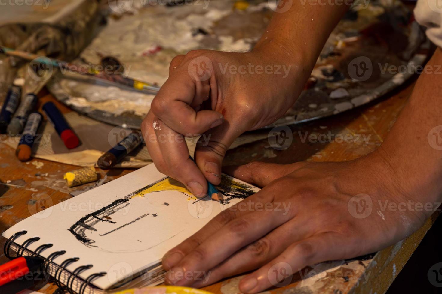 Artists workshop. Canvas, paint, brushes, palette knife lying on the table. photo