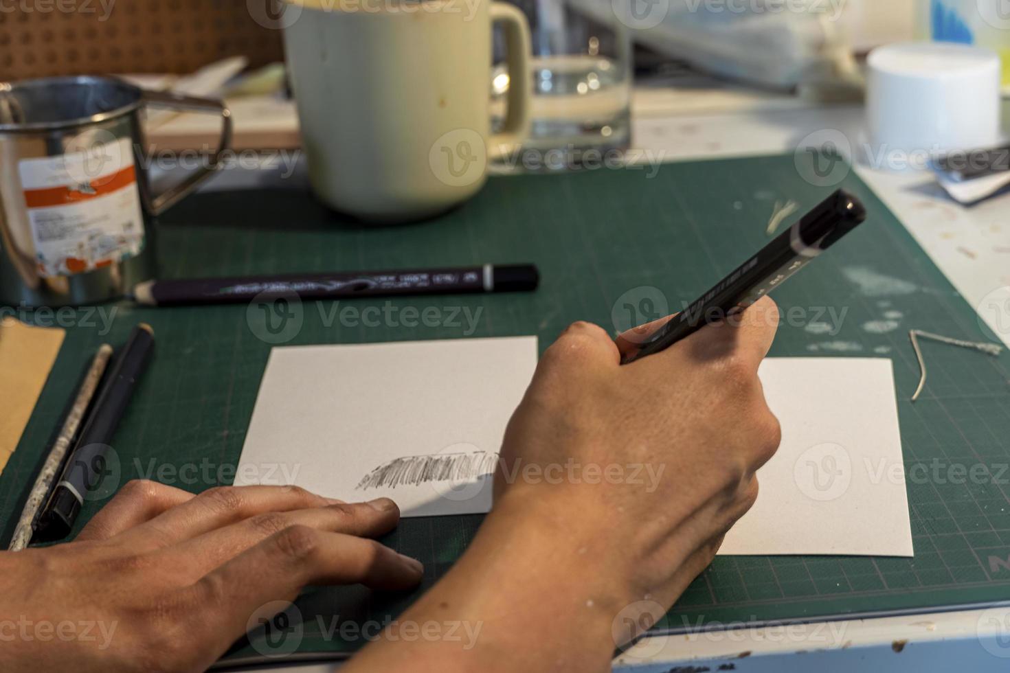 young latin woman, in her own painting studio, creates paintings different artistic techniques photo