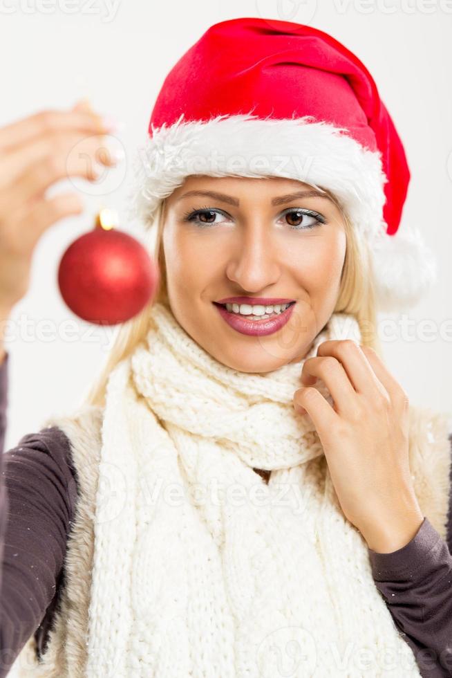 Santas Girl Holding A Christmas Decoration photo