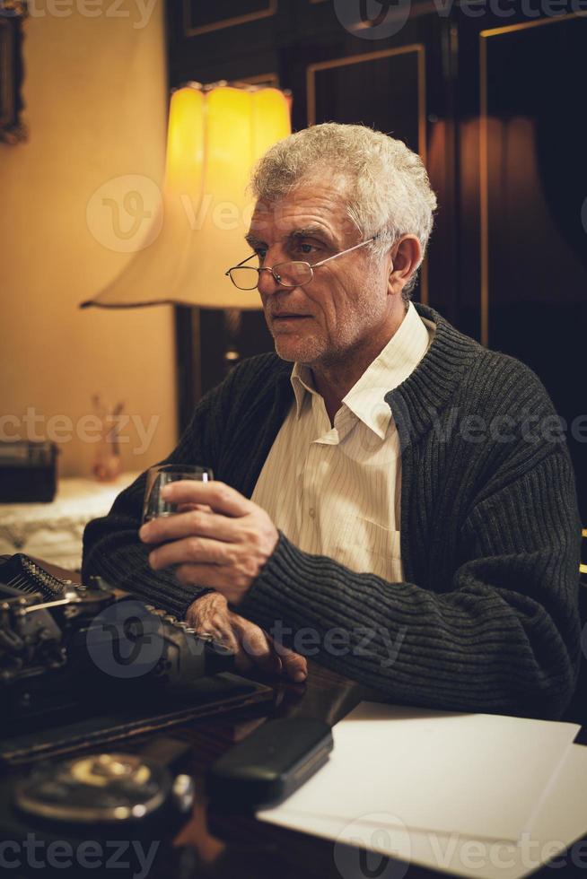 Retro Senior Man Writer With A Glass Of Whiskey photo