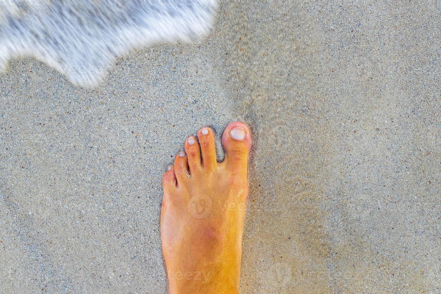 Walking barefoot on the beach sand by the water Mexico. photo