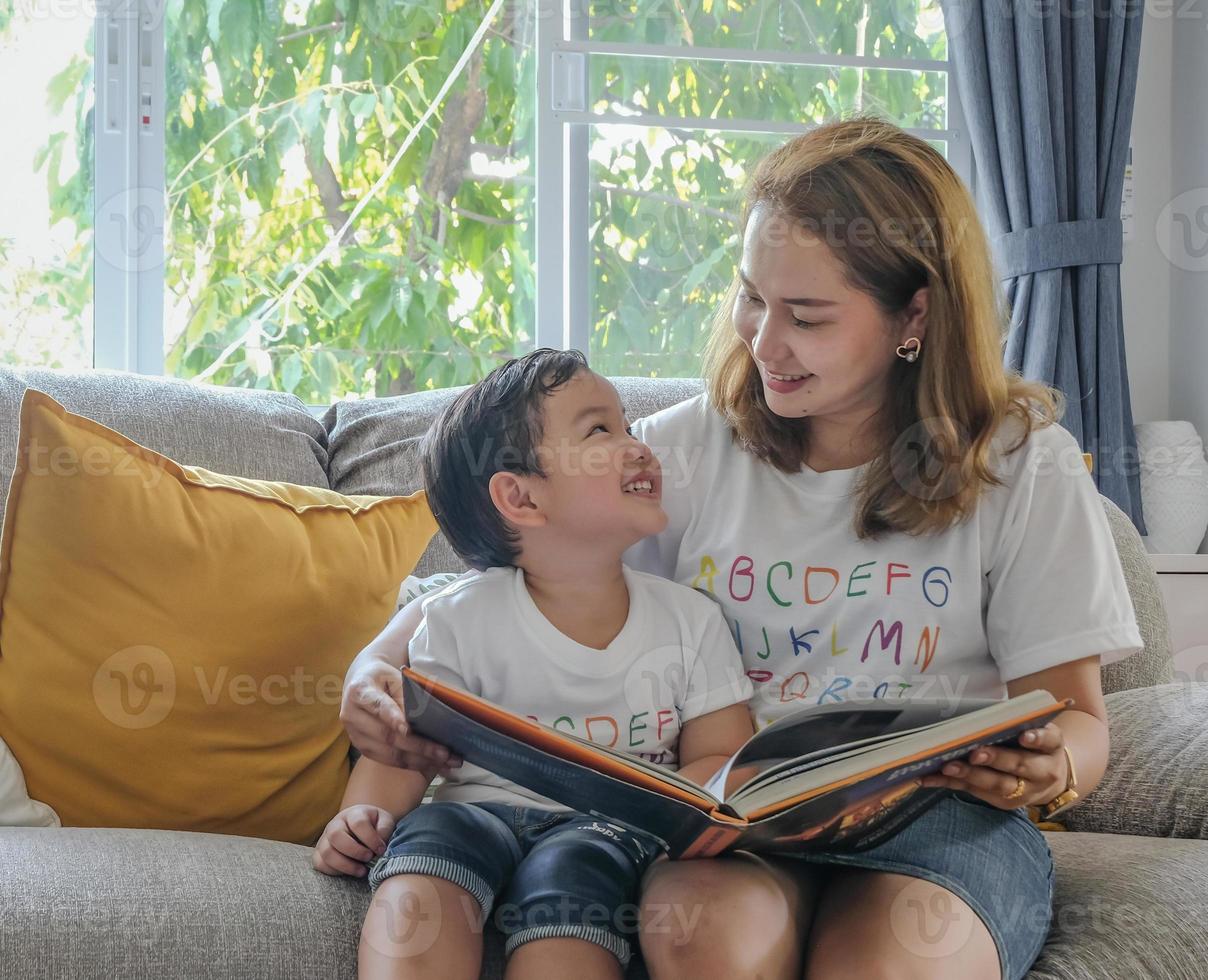 The eye contact between single mom and her son in school holidays happy moment. Asian home family lifestyle concept. photo