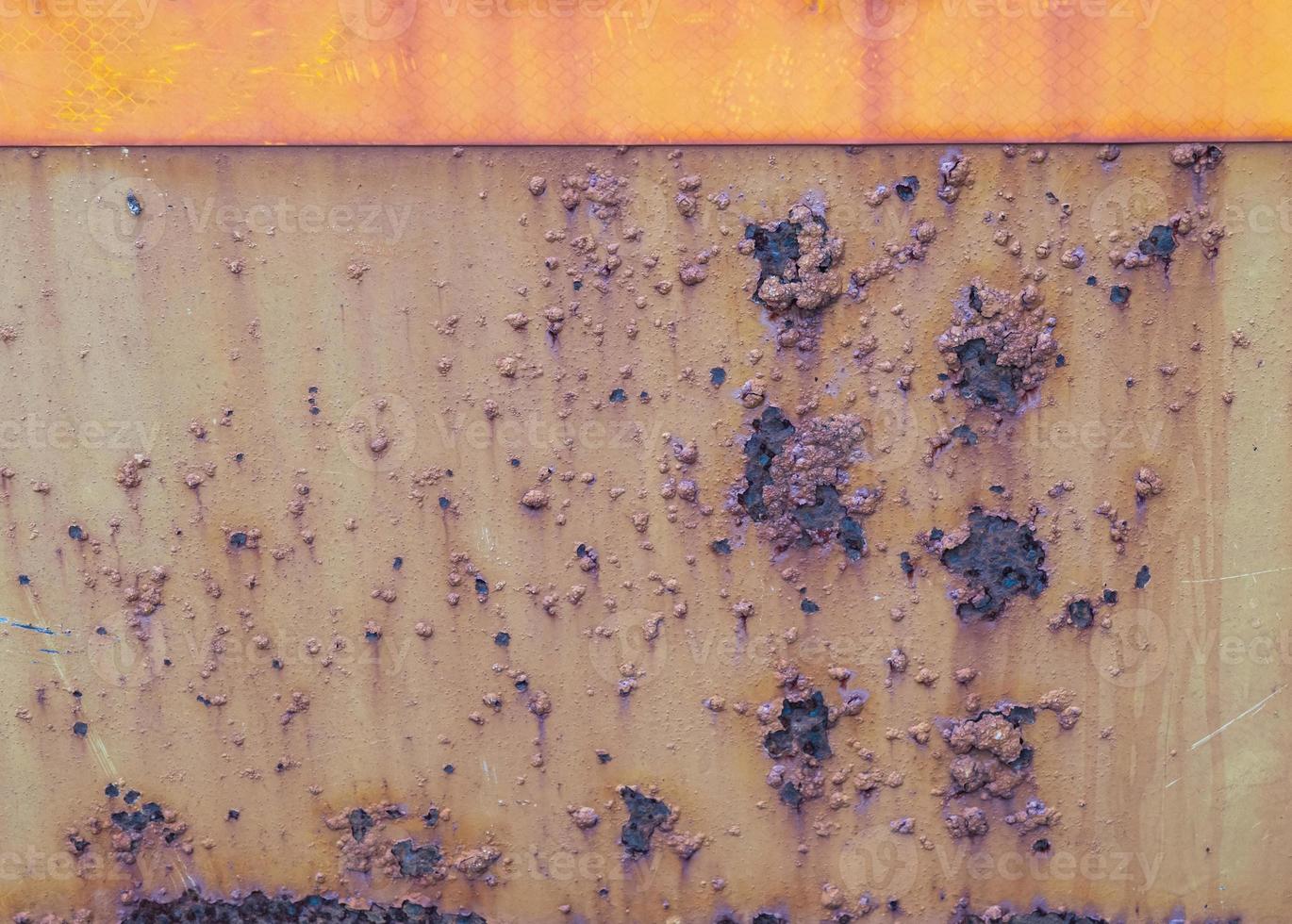 The surface of the rusted steel plate has stains, red-orange stains, scratches as the background. photo