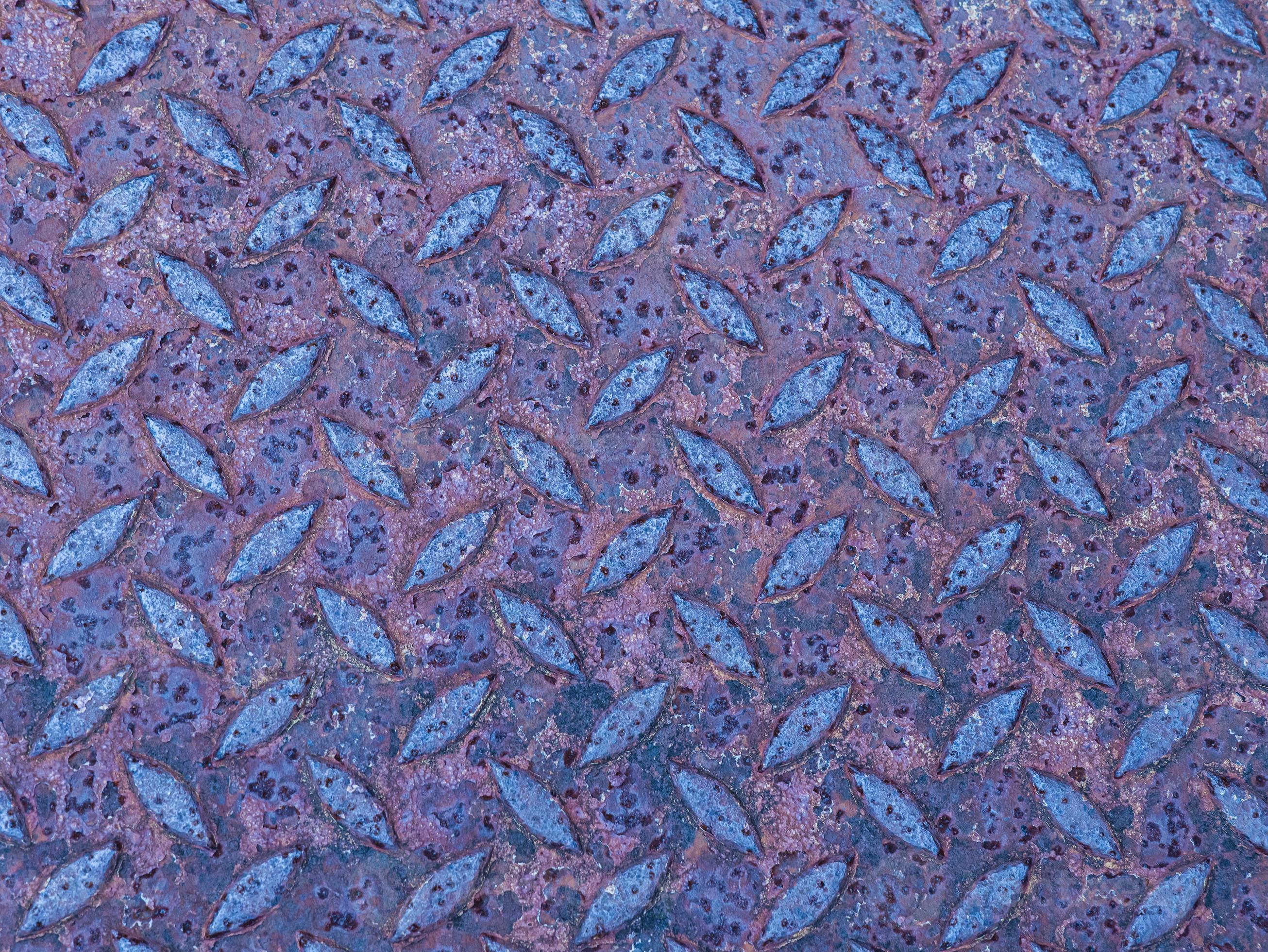 The rough surface of the rusted steel plate is stained, redorange, scratched as the background
