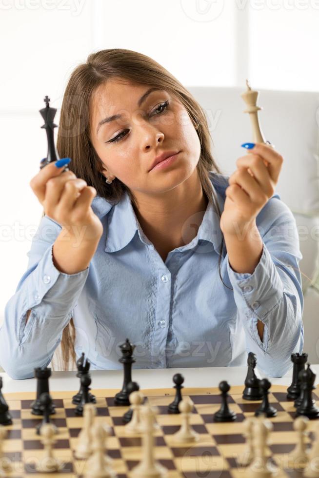 Young Pretty Businesswoman With Chess Pieces photo