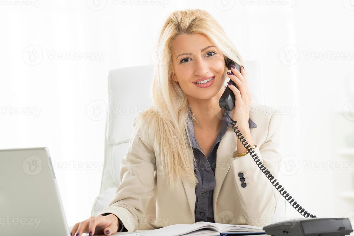 Blonde Businesswoman Phoning In The Office photo