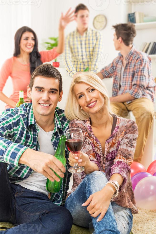 A Young Couple Toasting With Drinks photo