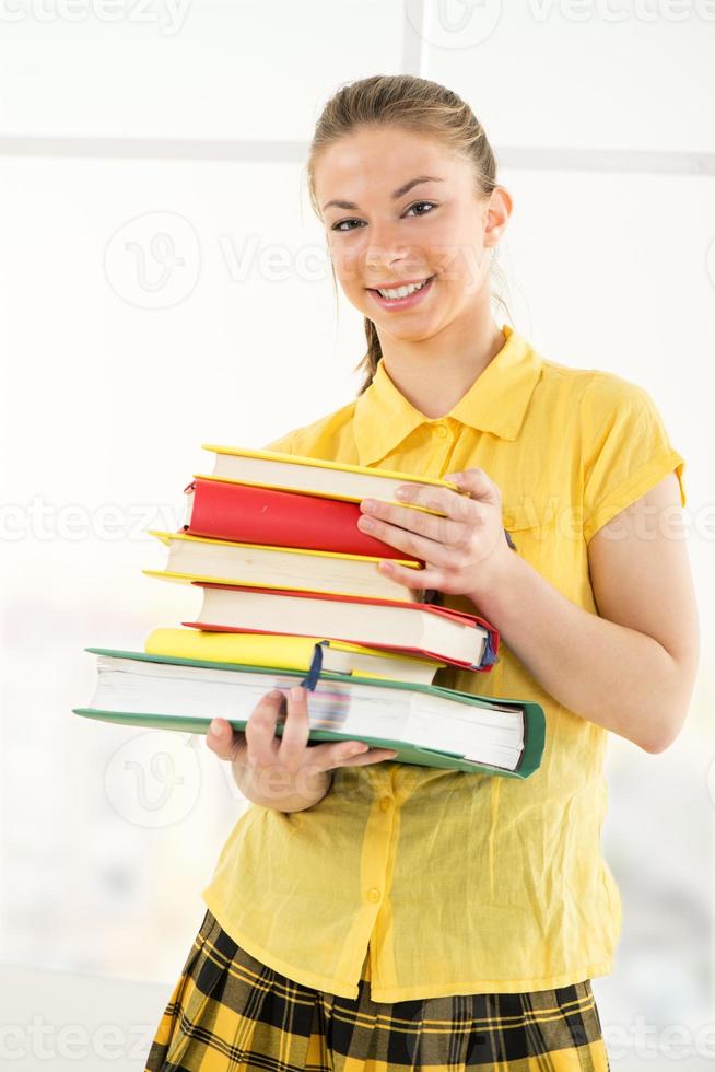 Happy Female student with books photo