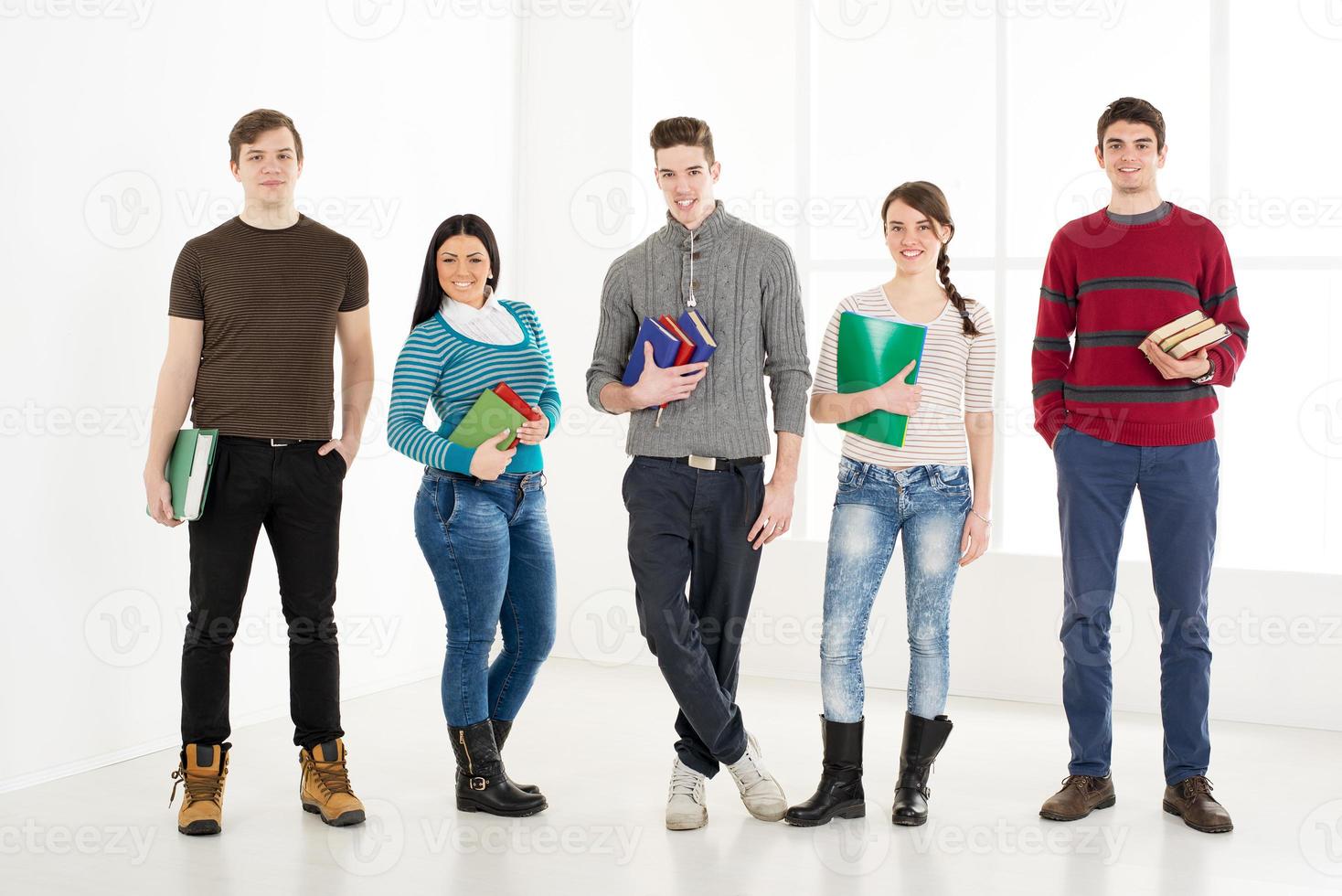 Group Of Smiling Students With Books. photo