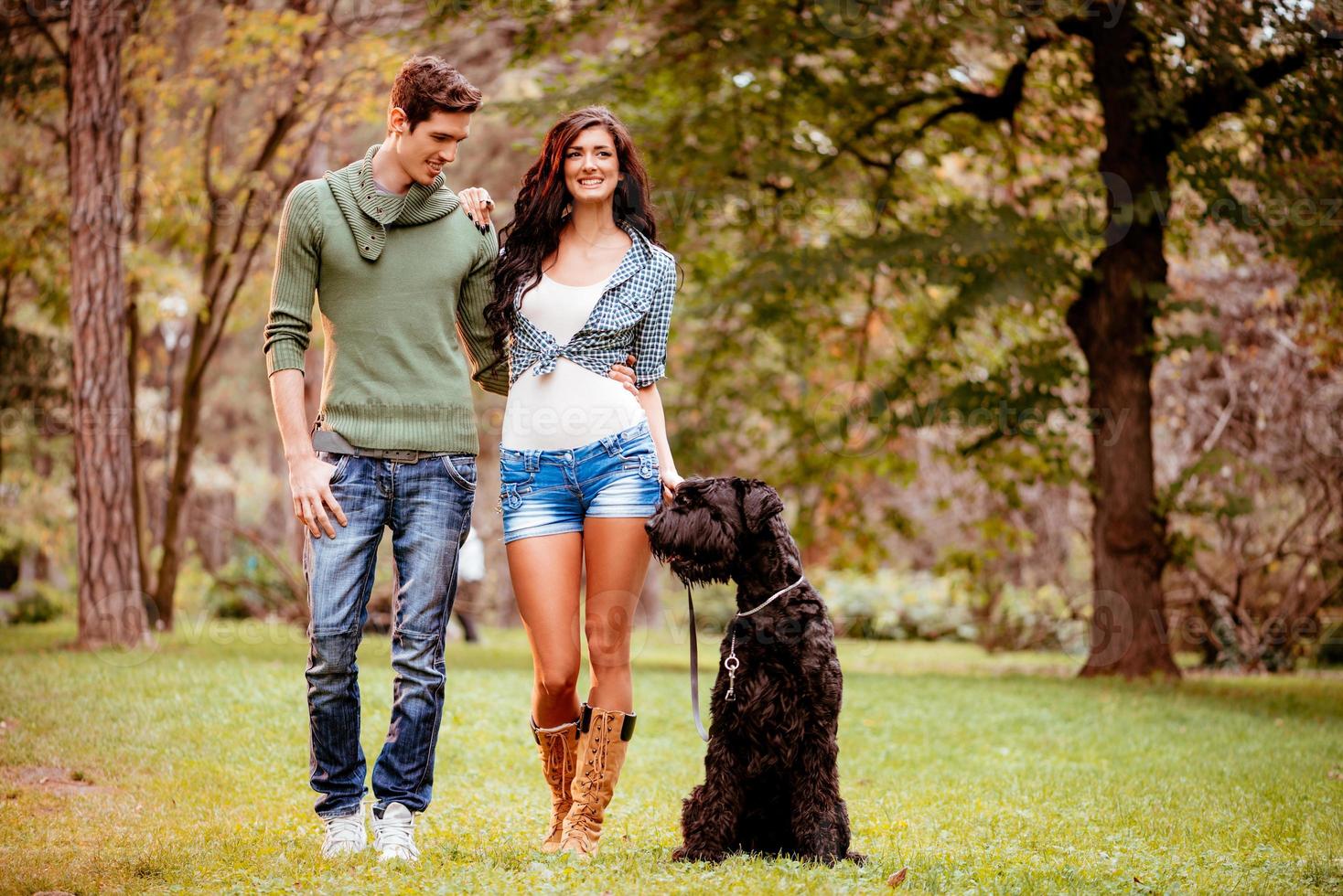 Smiling Couple With A Dog photo