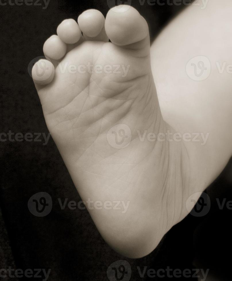 baby foot on a black background photo