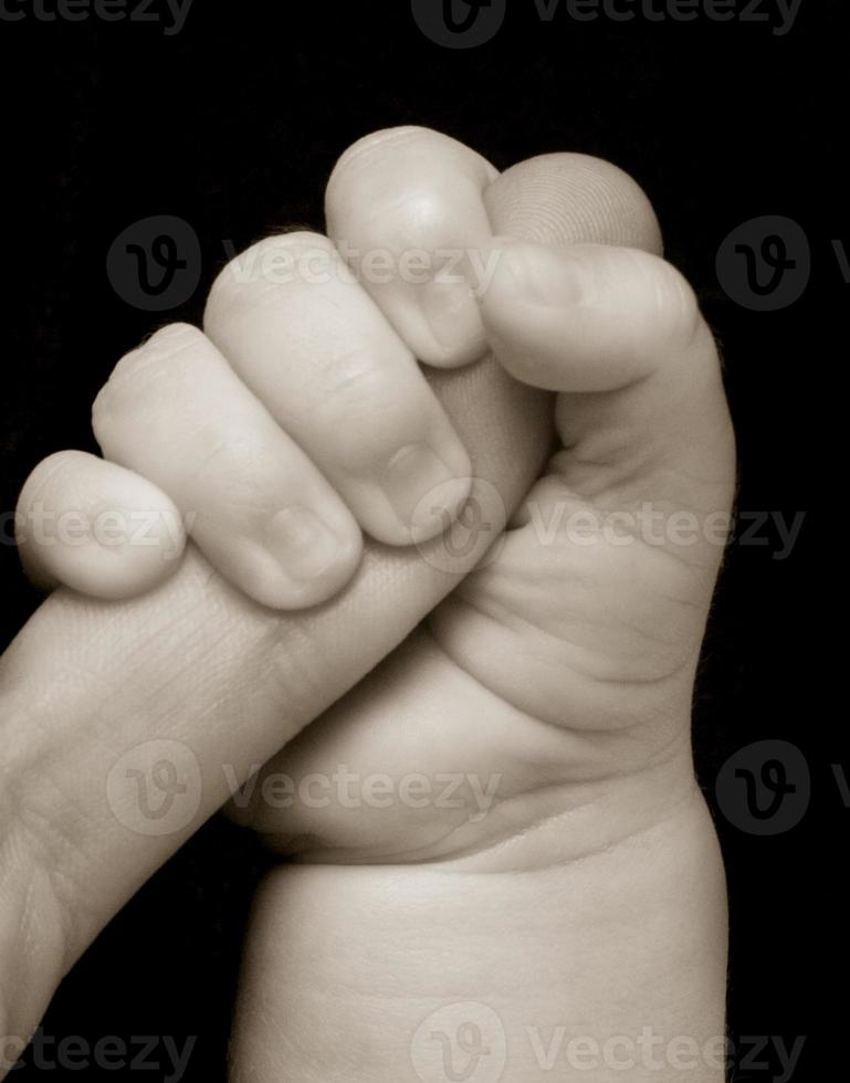 baby hand  on a black background photo