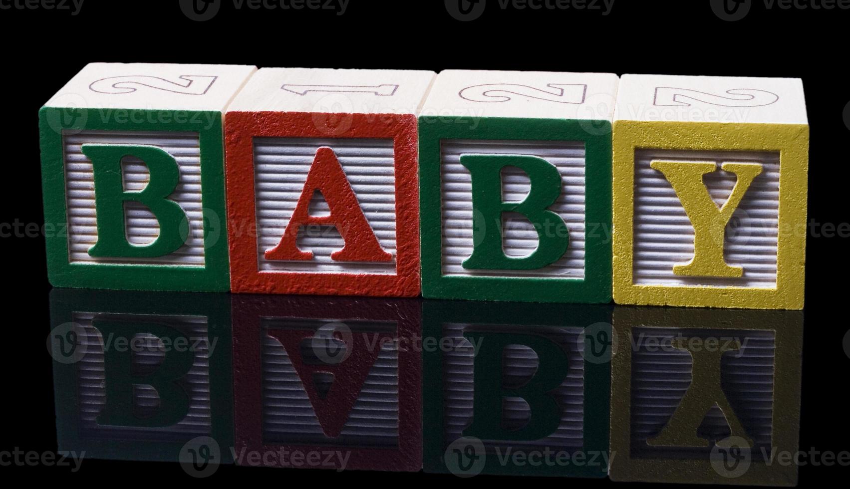 abc blocks on a shiny black background photo