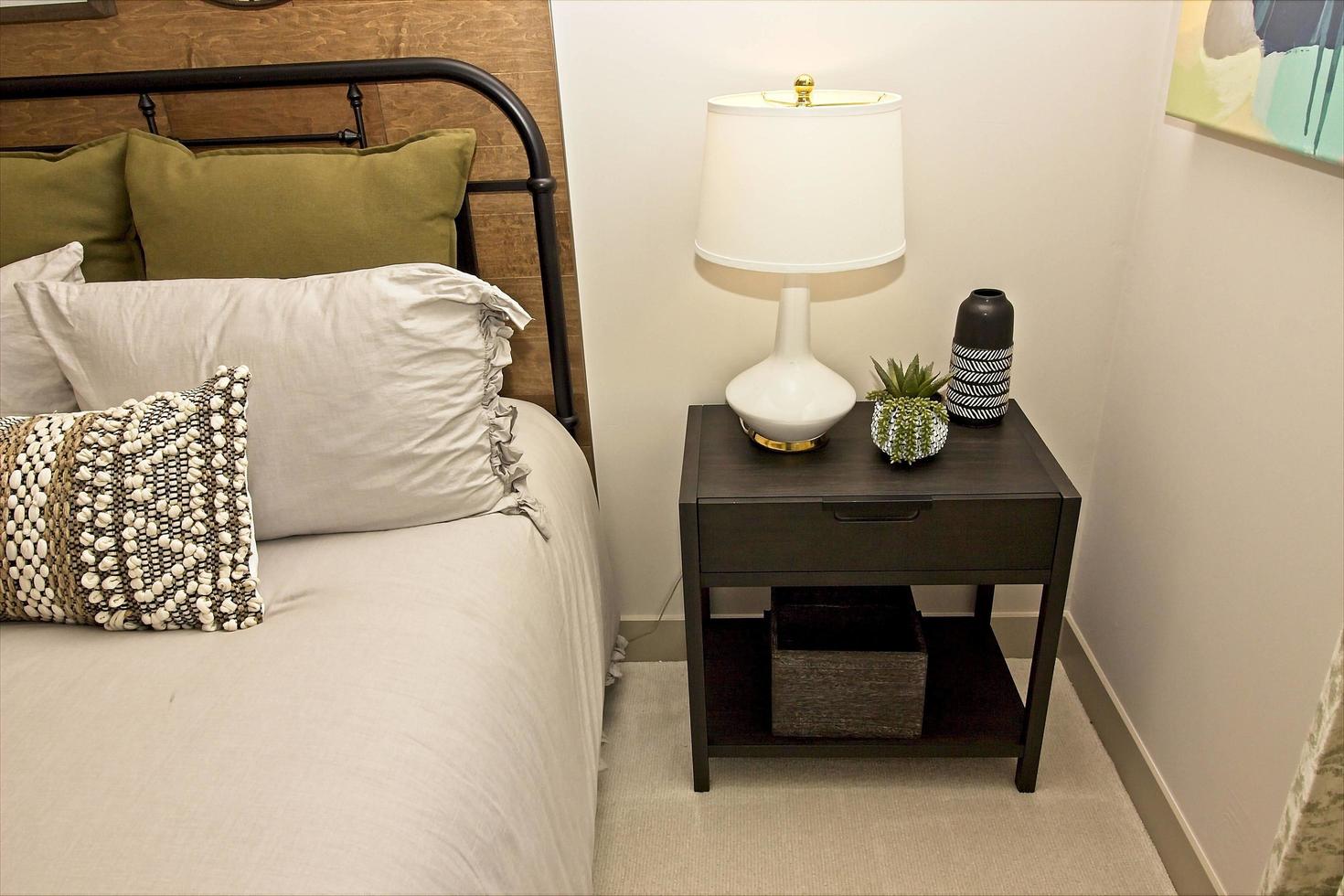 Master Bedroom Corner With Wooden Nightstand And Lamp photo