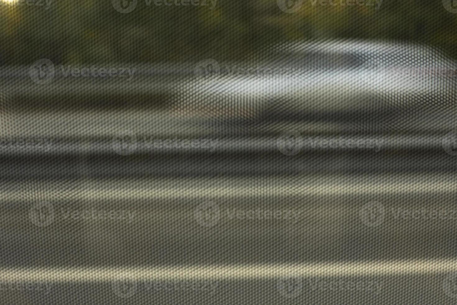 Texture of film on glass of bus. View through film to road. Blurred glass background. photo