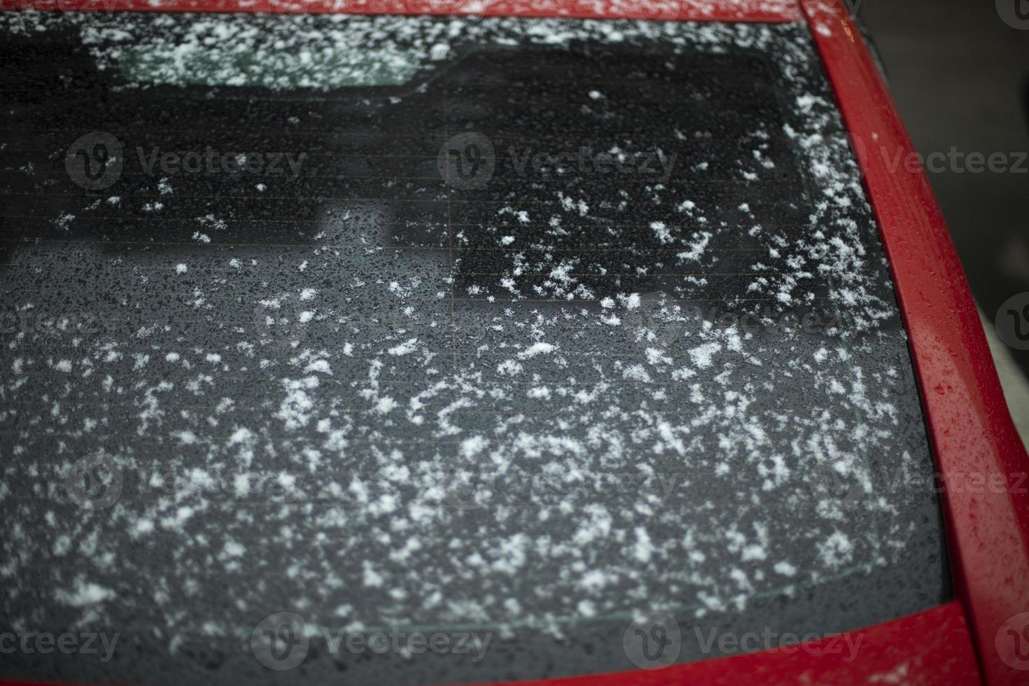 Snow on glass. Snow on car window. After snowstorm. Precipitation on surface. photo