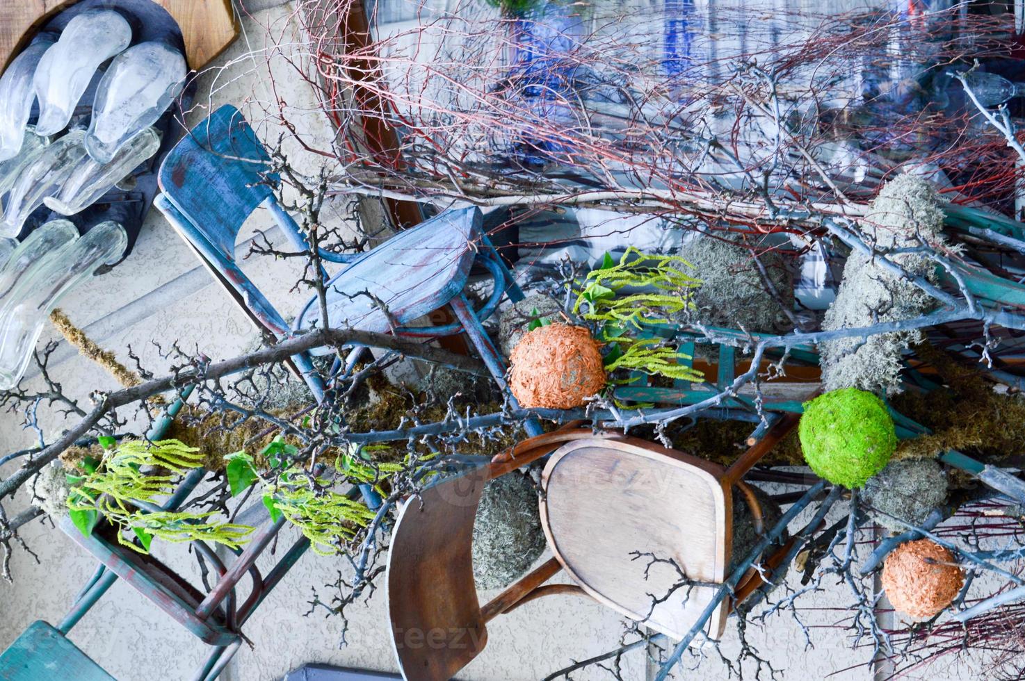 Abstract texture scattered in a chaotic random order of tree branches and wood stains with plants and wooden seats. The background photo