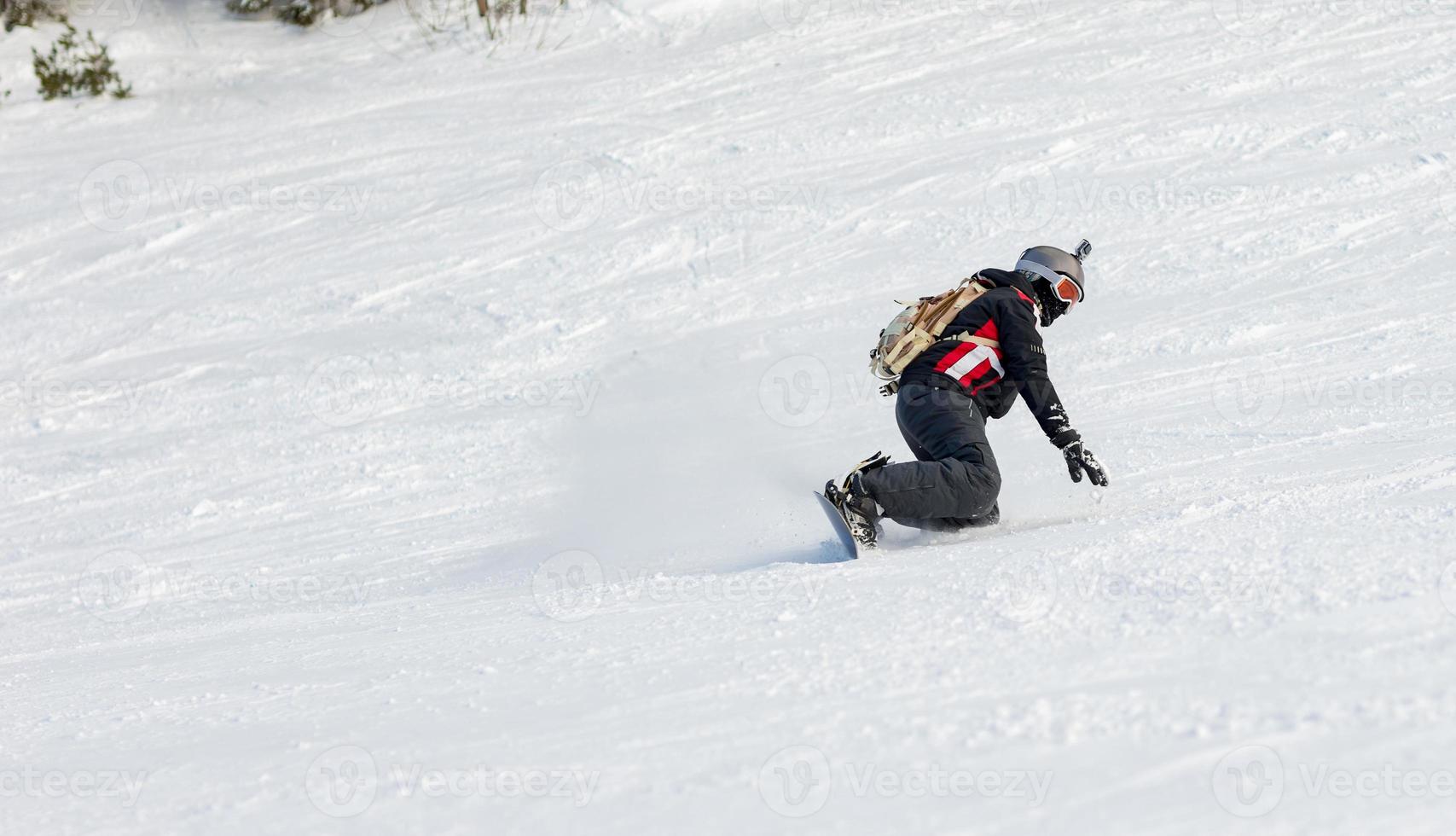 Snowboarder on hill photo