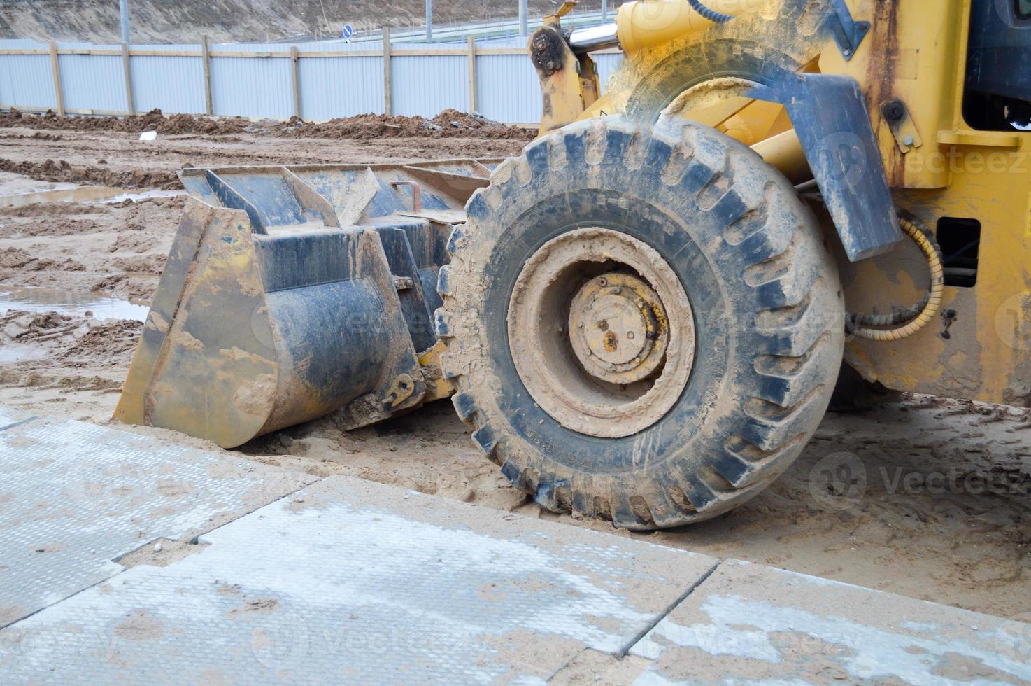 Large iron metal industrial heavy bucket of excavator, bulldozer, specialized construction equipment for road repair and excavation of the earth photo