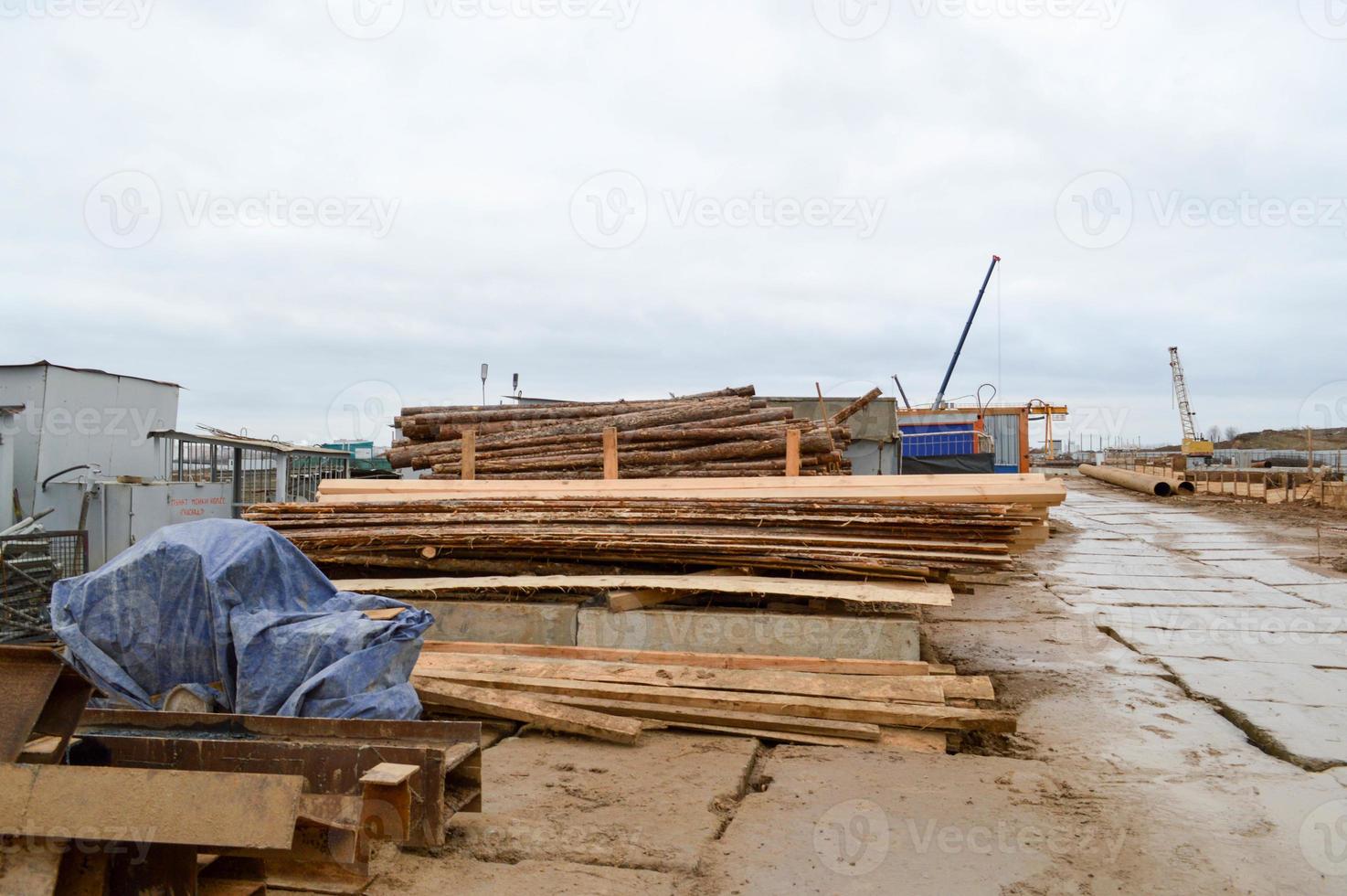 Lots of long wooden natural planed boards and sticks at a sawmill. The background. Texture. Concept timber harvesting for the wood industry photo
