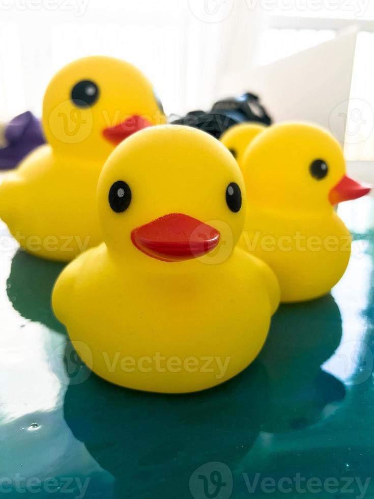 portrait of a rubber toy duck floating on a fluid art picture. yellow floating bird for games with children and adults. decoration for the bathroom photo