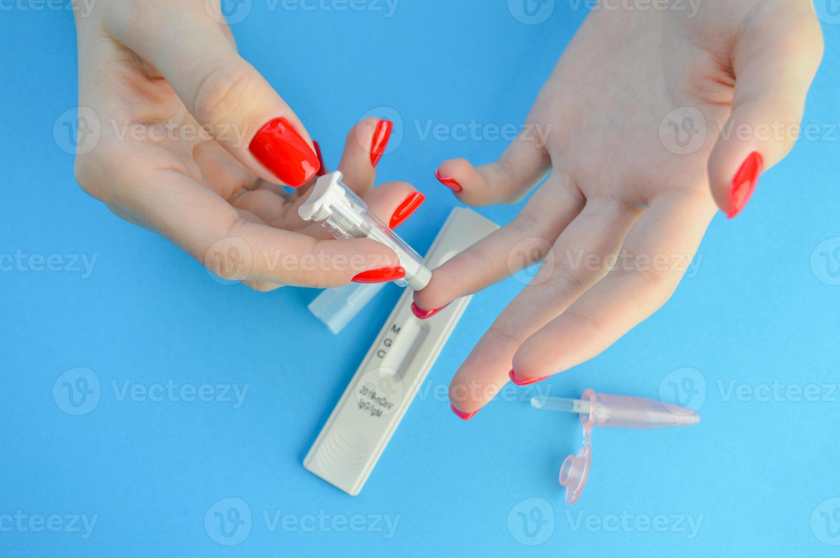 A Girl with a Bright Red Manicure Holds a Coronavirus Test and a Lancet for  a Blood Test in Her Hand. Determination of IgG and IgM Stock Photo - Image  of girl