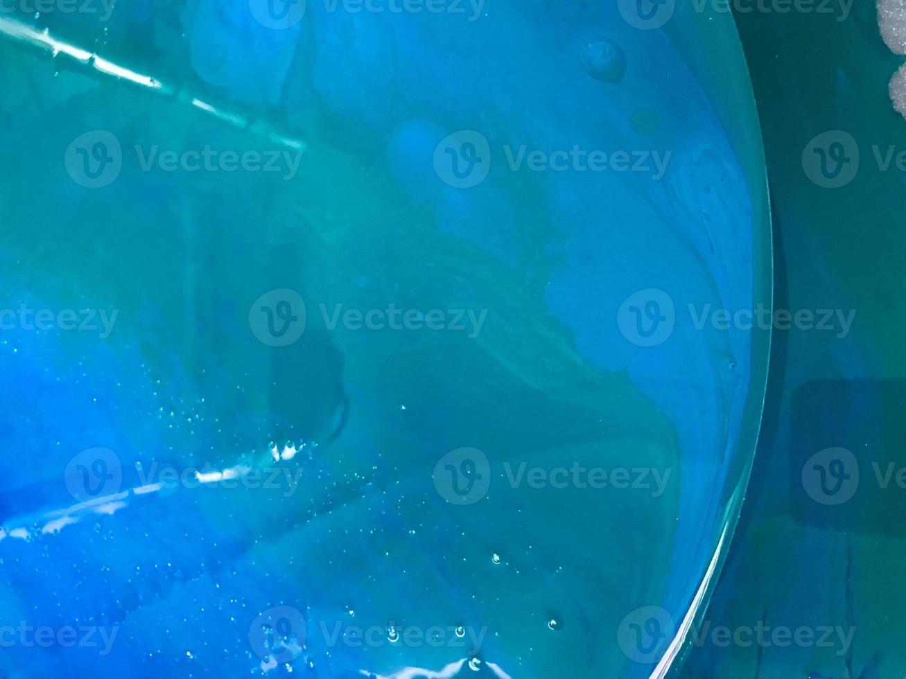 round abstract background, smooth surface of the pestilence in the technique of drawing epoxy. blue and white picture in a marine theme. wave with bubbles, glossy image with color highlights photo