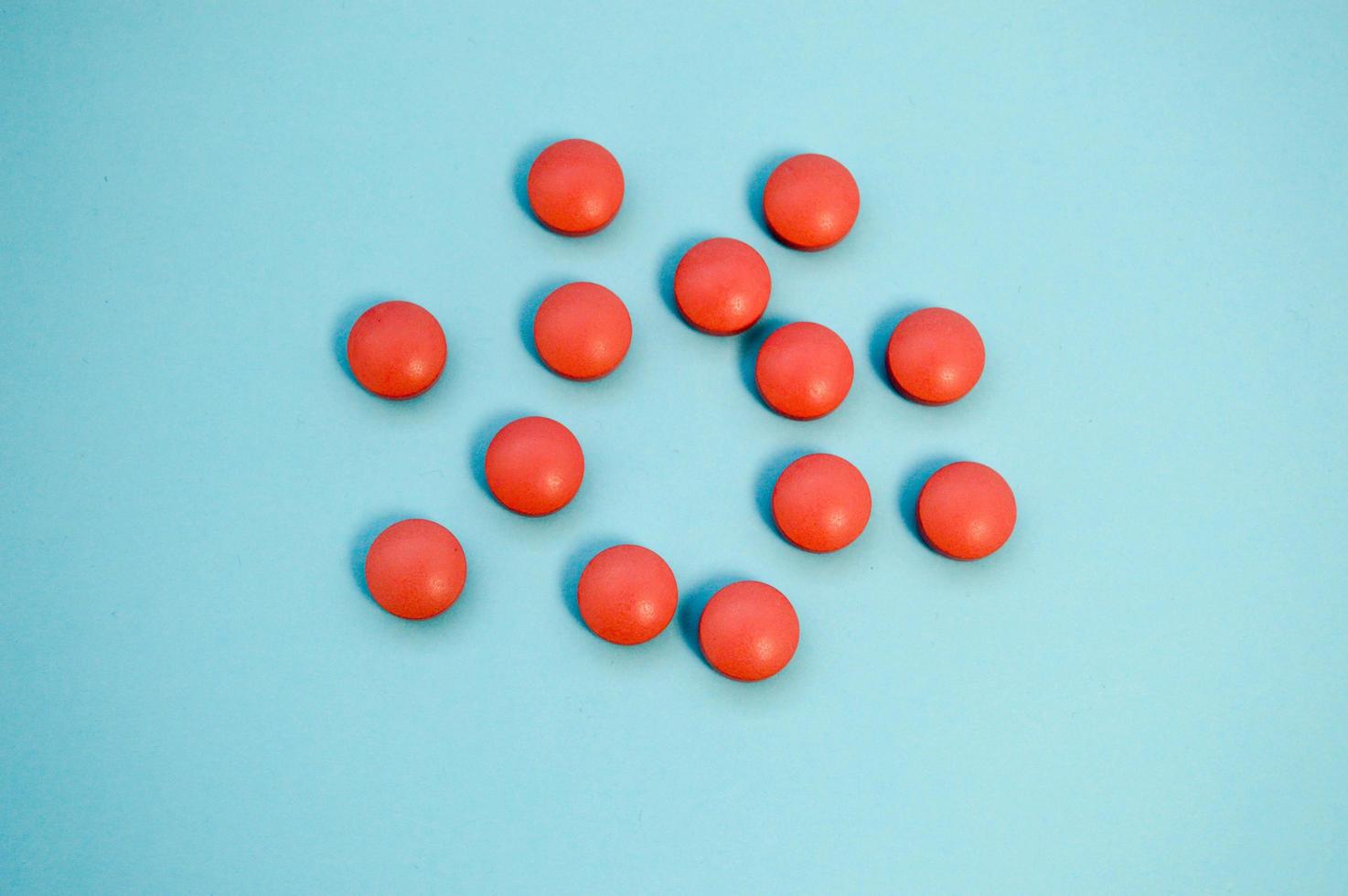 vitamin products for strengthening and human health. pills to support the body. pink medicines taken from a top angle in the shape of a circle and a flower photo