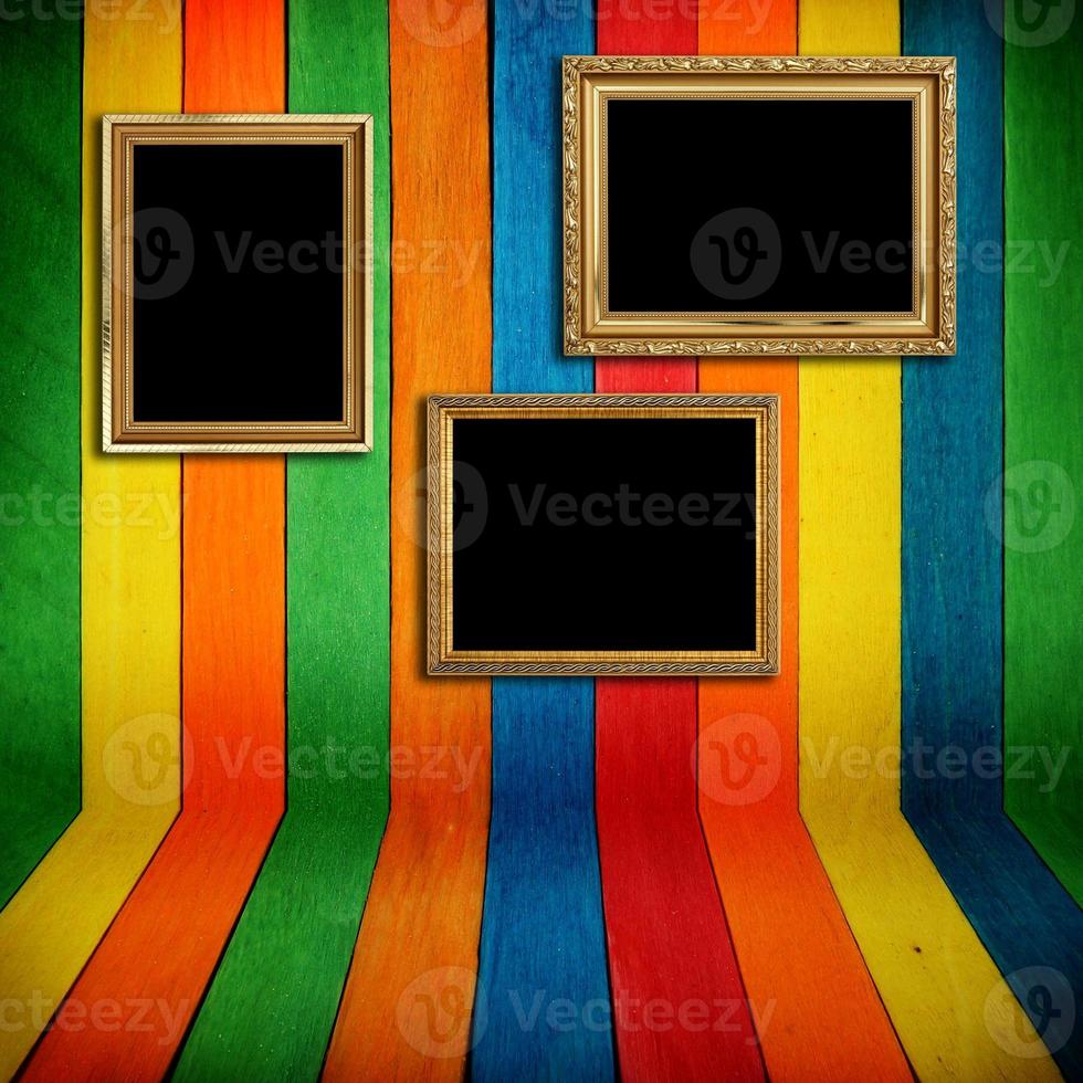 Gold frame on colorful wood Background photo