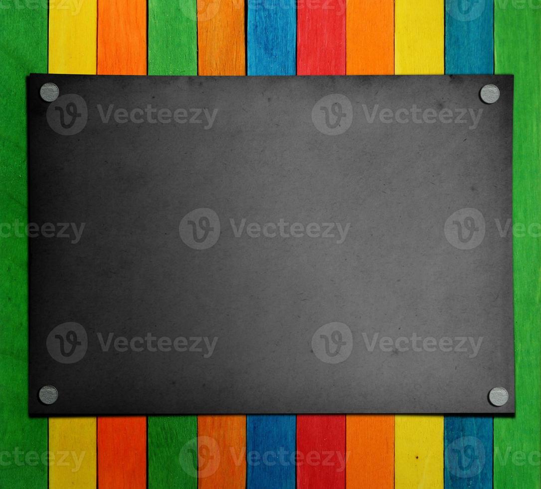 black paper on the colorful wood Background photo