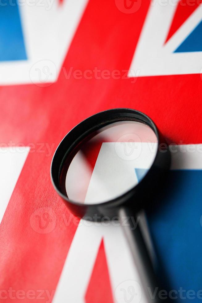 bandera del Reino Unido mirando a través de una lupa. el estudio de la historia y la cultura de la gente del gran país de Inglaterra. el concepto de estudiar geografía, costumbres y británicos. foto