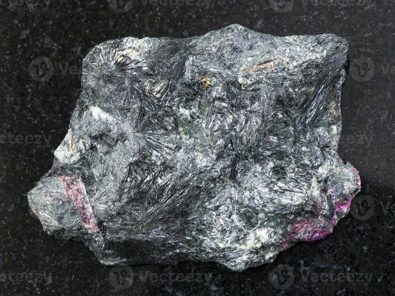 rough aegirine stone on dark background photo